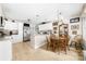 Bright kitchen features white cabinets, stainless steel appliances, tile flooring, and an eat-in dining area at 7029 Forest Hills Dr # 38, Denver, NC 28037