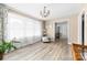 Bright living room with neutral walls, wood flooring, and a large window at 7029 Forest Hills Dr # 38, Denver, NC 28037