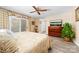 Comfortable main bedroom with neutral walls, wood flooring, a ceiling fan, and a sliding glass door at 7029 Forest Hills Dr # 38, Denver, NC 28037