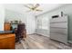 Office space with light green walls, a ceiling fan, and a desk with a brown office chair and a filing cabinet at 7029 Forest Hills Dr # 38, Denver, NC 28037