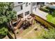 Aerial view showcases a two-story home with a tiered deck and landscaped backyard at 705 Mcalway Rd, Charlotte, NC 28211
