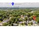 Aerial view overlooking mature trees and rooftops with the Charlotte skyline in the distance at 705 Mcalway Rd, Charlotte, NC 28211