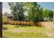Green backyard features a tall privacy fence, lush grass, and the back of a home at 705 Mcalway Rd, Charlotte, NC 28211