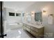 Bright bathroom featuring a free-standing tub, double vanity, and gold fixtures at 705 Mcalway Rd, Charlotte, NC 28211