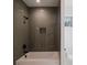 This bathroom features stylish shower with gray subway tiles, a white tub, and black fixtures at 705 Mcalway Rd, Charlotte, NC 28211