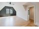 Light-filled bedroom with hardwood floors, gray accent wall, and trim work at 705 Mcalway Rd, Charlotte, NC 28211