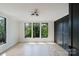 Bright bedroom featuring hardwood floors, three large windows, and a dark accent wall at 705 Mcalway Rd, Charlotte, NC 28211