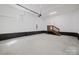 Spacious garage featuring high ceilings, a small staircase and pristine white walls, perfect for multiple vehicles at 705 Mcalway Rd, Charlotte, NC 28211