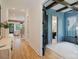 Hallway view showcasing hardwood floors, trim detail, and an office with an ensuite at 705 Mcalway Rd, Charlotte, NC 28211