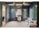 Stylish home office with gray walls, wood floors, ample windows, and cozy seating area perfect for remote work at 705 Mcalway Rd, Charlotte, NC 28211