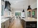 Island kitchen with quartz counters, shaker cabinets, stainless steel appliances, and pendant lighting at 705 Mcalway Rd, Charlotte, NC 28211