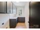 Functional laundry room with sleek gray cabinetry, ample counter space, and a convenient sink, perfect for chores at 705 Mcalway Rd, Charlotte, NC 28211