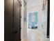 Charming mudroom featuring wood flooring, a built-in bench, decorative lighting, and a soothing blue accent wall at 705 Mcalway Rd, Charlotte, NC 28211