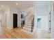 Inviting staircase featuring wood and black accents, flowing seamlessly into the home's bright, open living space at 705 Mcalway Rd, Charlotte, NC 28211