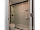 Updated bathroom with shower and glass sliding door, offering a clean and modern aesthetic at 7916 Charter Oak Ln, Charlotte, NC 28226