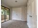Well-lit bedroom with access to a private porch with views of surrounding greenery, offering a calm oasis at 7916 Charter Oak Ln, Charlotte, NC 28226