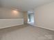 Expansive bonus room area with access to the entry stairs, perfect for entertaining and relaxing at 7916 Charter Oak Ln, Charlotte, NC 28226