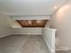 Large bonus room with wood beam ceiling and neutral carpet, providing ample flexible space at 7916 Charter Oak Ln, Charlotte, NC 28226