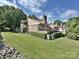 Attractive two-story brick home with chimney, mature landscaping and well-kept lawn at 7916 Charter Oak Ln, Charlotte, NC 28226