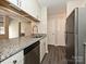 Open-concept kitchen with granite counters, stainless steel appliances and hardwood floors at 7916 Charter Oak Ln, Charlotte, NC 28226