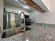 Close-up of kitchen features stainless steel appliances, granite countertops and a tablet device at 7916 Charter Oak Ln, Charlotte, NC 28226