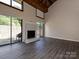 Bright living room featuring a fireplace, vaulted ceilings, and access to a patio at 7916 Charter Oak Ln, Charlotte, NC 28226