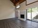 Bright living room featuring a fireplace, vaulted ceilings, and access to a patio at 7916 Charter Oak Ln, Charlotte, NC 28226