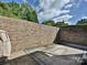 Enclosed patio with brick surround and outdoor rug; perfect for relaxing in privacy at 7916 Charter Oak Ln, Charlotte, NC 28226