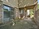 Covered patio area with brick accents and sliding glass doors for indoor-outdoor living at 7916 Charter Oak Ln, Charlotte, NC 28226
