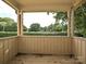 Inviting covered porch with views of mature trees, creating a relaxing outdoor space at 7916 Charter Oak Ln, Charlotte, NC 28226