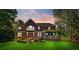 Expansive backyard with well-maintained lawn, patio seating, and screened porch at 8102 Bergen Ct, Waxhaw, NC 28173