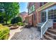 Brick patio with outdoor seating, fire pit, grill, and well-maintained landscaping at 8102 Bergen Ct, Waxhaw, NC 28173