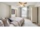 Cozy bedroom with large window, neutral decor, ceiling fan, and ample natural light at 8102 Bergen Ct, Waxhaw, NC 28173