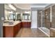 Elegant bathroom featuring double vanity, tiled floor, and glass-enclosed shower at 8102 Bergen Ct, Waxhaw, NC 28173