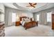Bright and spacious main bedroom with tray ceiling, plush carpet, and large windows at 8102 Bergen Ct, Waxhaw, NC 28173
