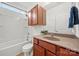 Bright bathroom featuring a tub-shower combo, wood vanity, and white walls at 8312 Compton Acres Ln, Waxhaw, NC 28173