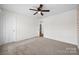 A bedroom with light walls, ceiling fan and neutral carpet at 8312 Compton Acres Ln, Waxhaw, NC 28173