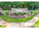 Stone community entrance sign with landscaping, flowers, and manicured lawn at 8312 Compton Acres Ln, Waxhaw, NC 28173