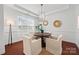 Bright dining area with hardwood floors, a modern light fixture, and ample natural light at 8312 Compton Acres Ln, Waxhaw, NC 28173