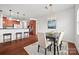 Bright dining area with a stylish chandelier, dark wood floors, and easy access to the kitchen bar seating at 8312 Compton Acres Ln, Waxhaw, NC 28173