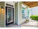 Inviting front entryway featuring a decorative door, sidelight windows, bench, and covered porch at 8312 Compton Acres Ln, Waxhaw, NC 28173