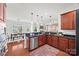 Open kitchen with dark granite counters, stainless steel appliances and seamless flow into the adjacent dining and living areas at 8312 Compton Acres Ln, Waxhaw, NC 28173