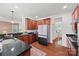 Spacious kitchen with granite countertops, stainless steel appliances, and rich cabinetry adjacent to dining space at 8312 Compton Acres Ln, Waxhaw, NC 28173