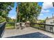 Open back deck featuring a black railing, wood flooring, and table with chairs at 909 Gibbons St, Gastonia, NC 28052