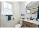 Bright bathroom with natural lighting, a mirror, and neutral decor creating a serene space at 909 Gibbons St, Gastonia, NC 28052