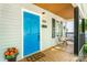 Close-up of the front porch featuring a blue door, seating, and seasonal decorations, creating a warm welcome at 909 Gibbons St, Gastonia, NC 28052