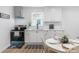Modern kitchen featuring white cabinets, subway tile backsplash, stainless steel appliances, and eat in dining at 909 Gibbons St, Gastonia, NC 28052