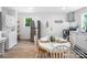 Contemporary kitchen featuring new appliances, white cabinets, adjacent dining area and luxury vinyl flooring at 909 Gibbons St, Gastonia, NC 28052