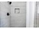 Beautiful shower with a neutral white tile and black hardware at 909 Gibbons St, Gastonia, NC 28052