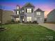 Charming two-story home with manicured lawn, stone accents, and attached two car garage at 9582 Creighton Nw Rd, Concord, NC 28027